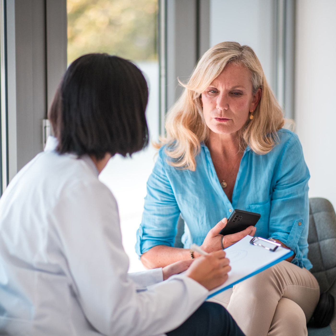 Consultant gynaecologist with a patient before a hysteroscopy at Enigma Healthcare in Tarporley.