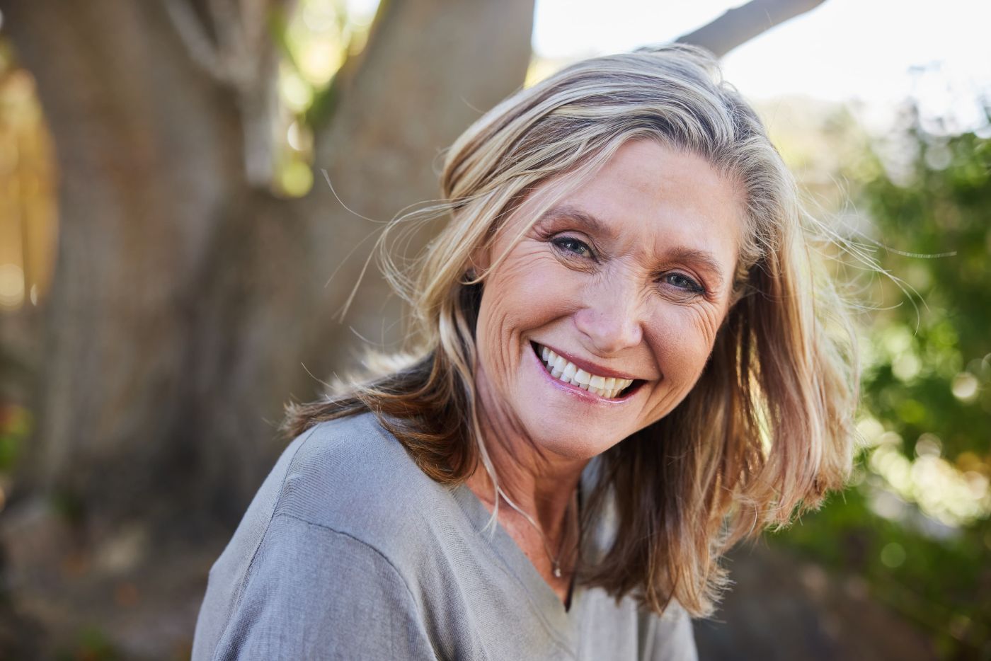 Smiling woman in midlife enjoying time outdoors