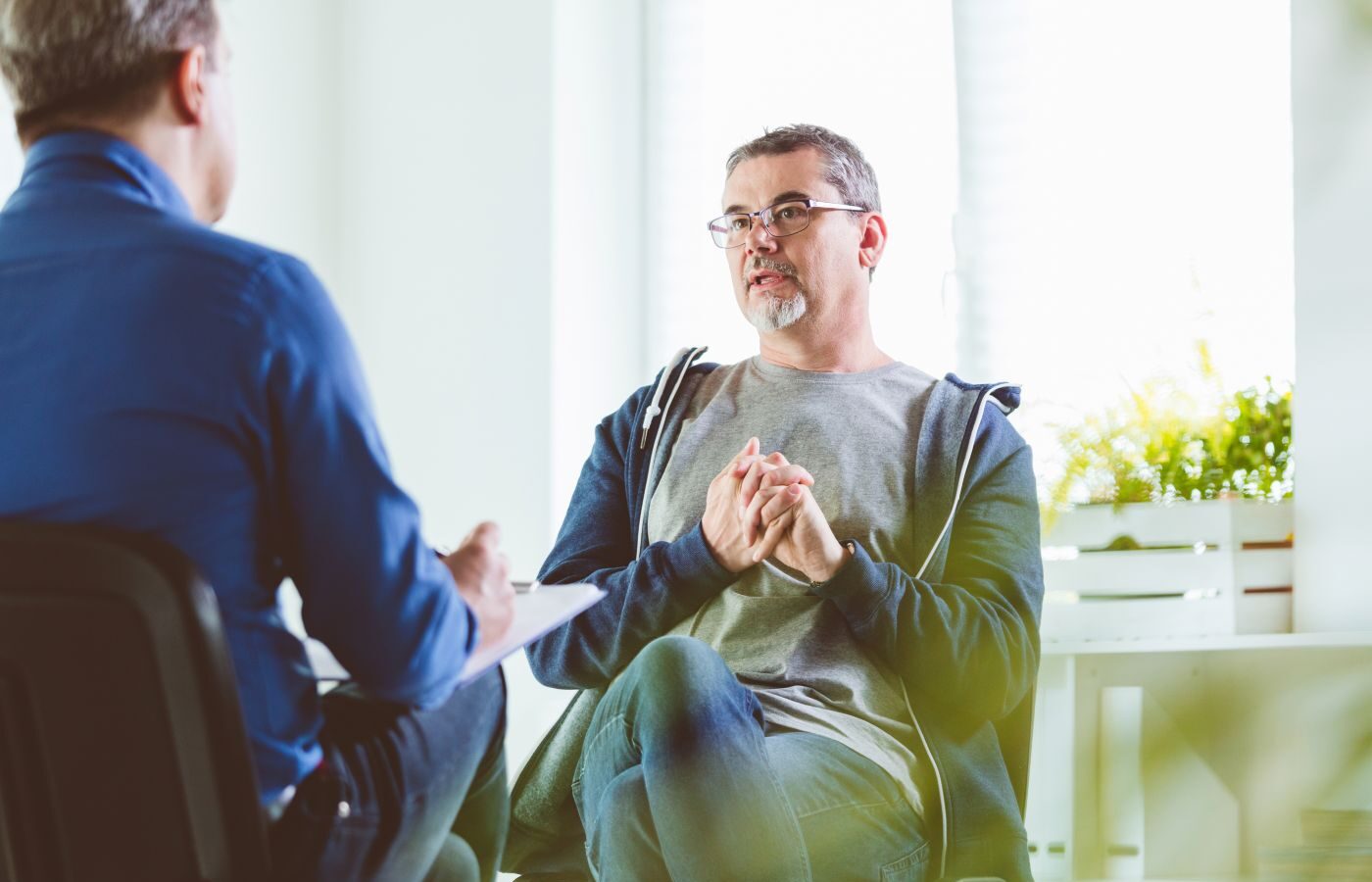 Man discussing his health with a healthcare professional during a consultation