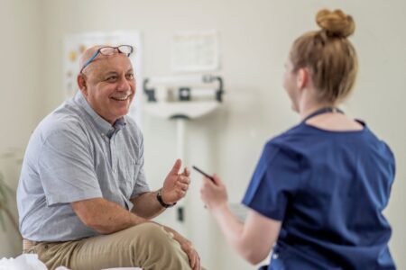 Man discussing his health with a healthcare professional during a consultation