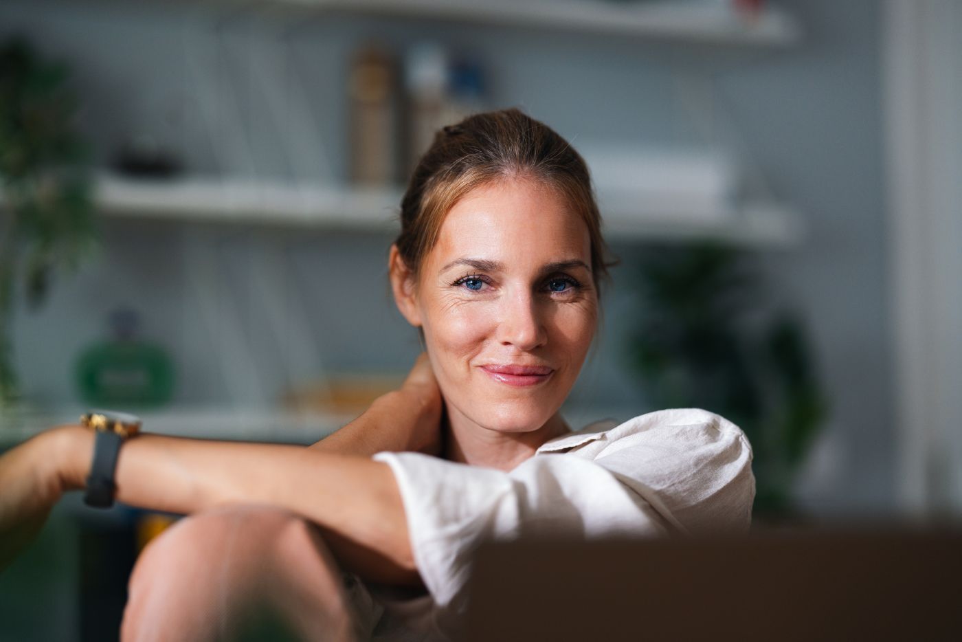 Woman smiling at home, representing women’s gynaecological health and wellbeing